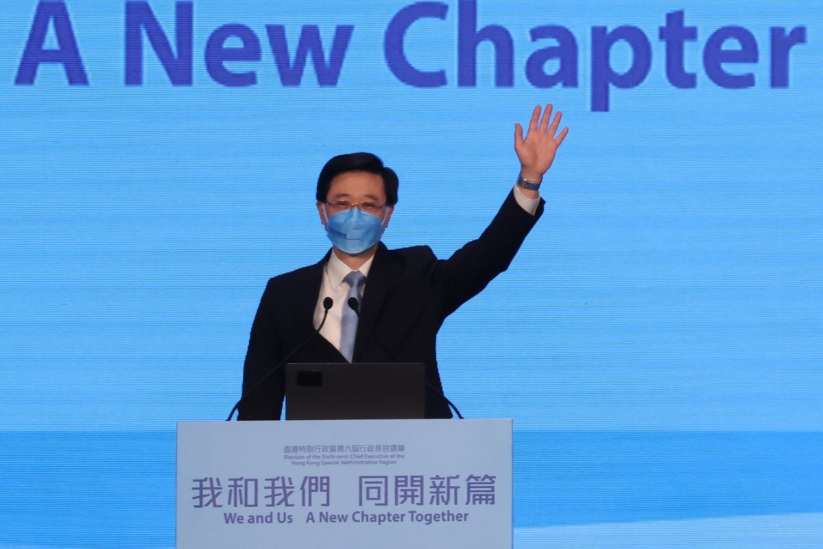 John Lee waves during his rally at the Hong Kong Convention and Exhibition Centre. Photo: Felix Wong
