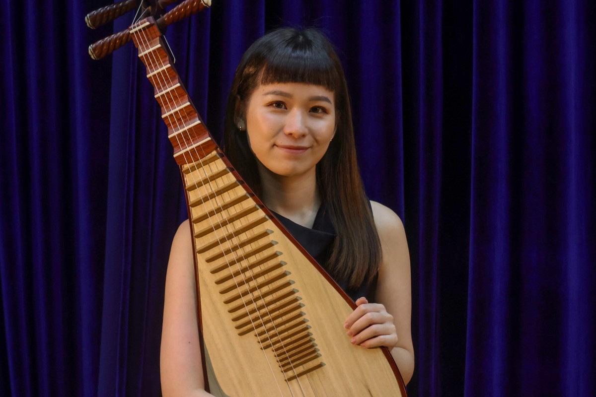 Hong Kong Chinese Orchestra member Wang Kaihan sits with her pipa. Photo: Jonathan Wong