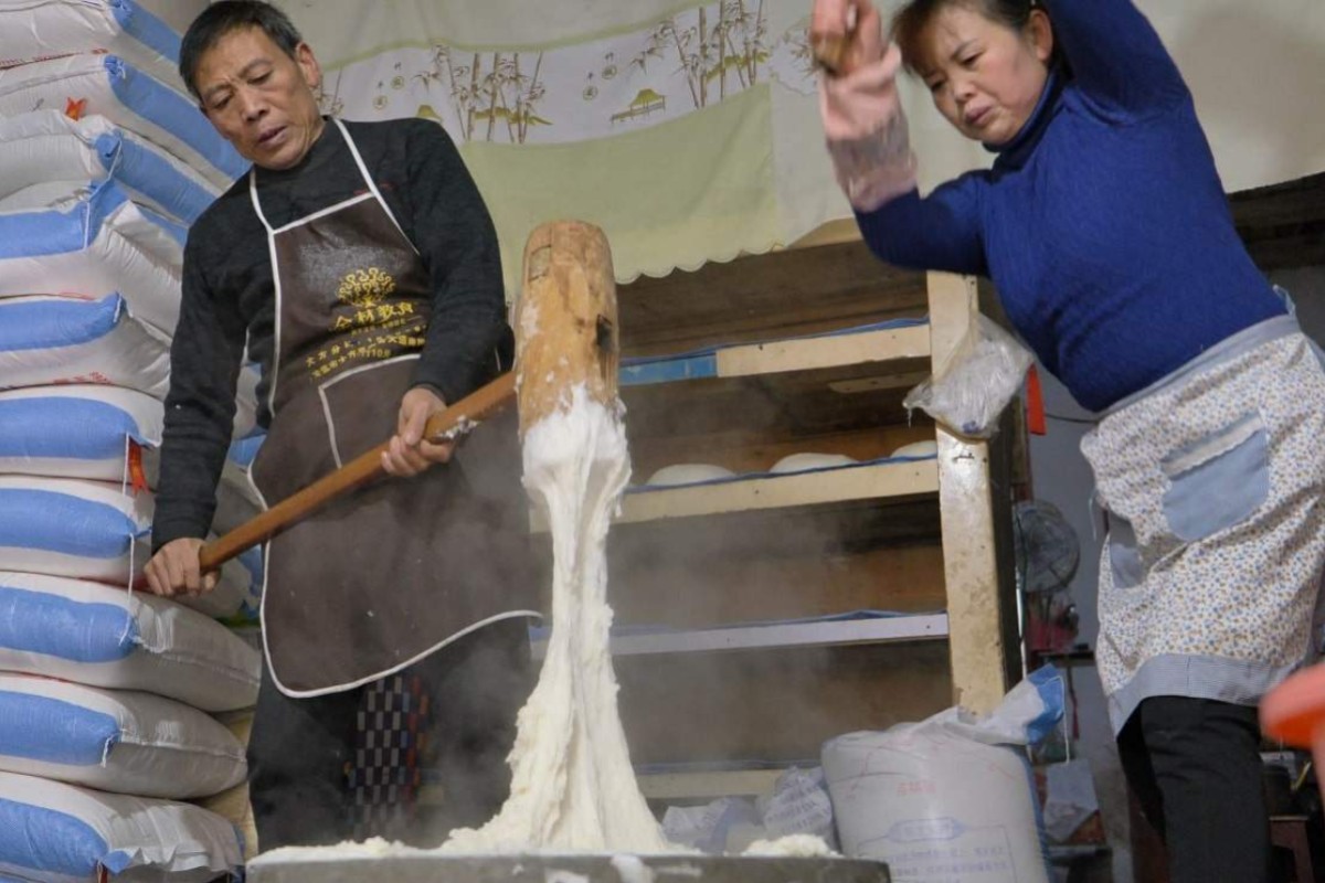 Wang and his wife pounding the rice into a sticky paste. Photo: Goldthread