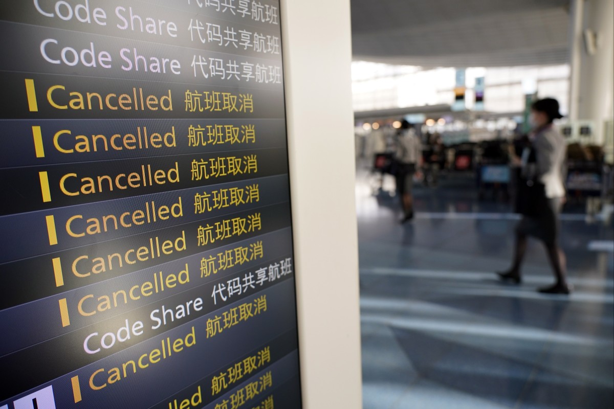 A board shows cancelled international flights at Haneda International Airport in Tokyo, Japan, on November 29, 2021. Japan is among a number of Asian countries that have enforced more stringent travel restrictions in response to the Omicron threat. Photo: EPA-EFE