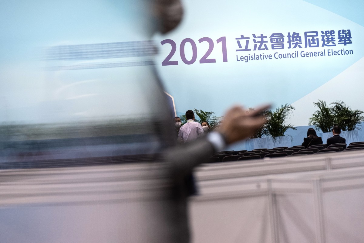An attendee walks past the stage for the Legislative Council election in Hong Kong, early on December 20. The newly elected legislators have a historic mission to rebuild Hong Kong under Beijing’s rules. Photo: Bloomberg