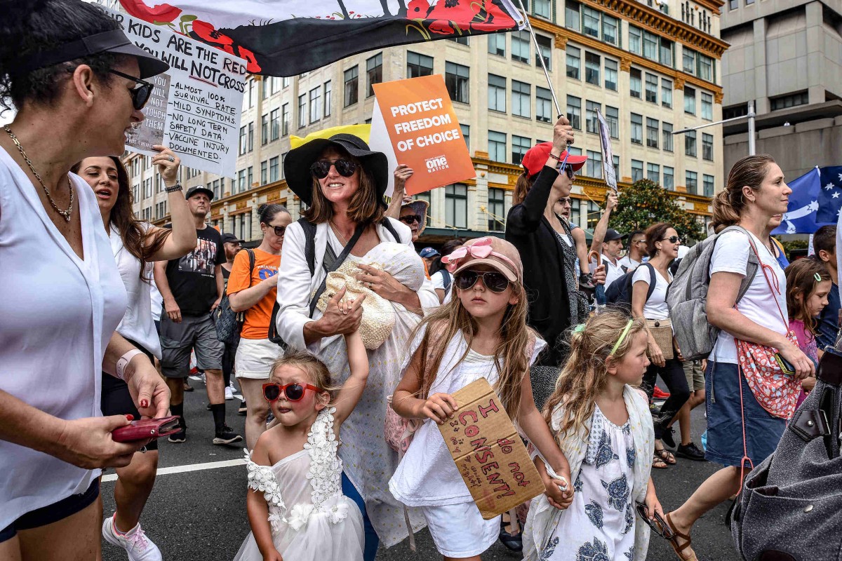 Protesters are seen with their children at an anti-vaccination rally in Sydney. Photo: dpa