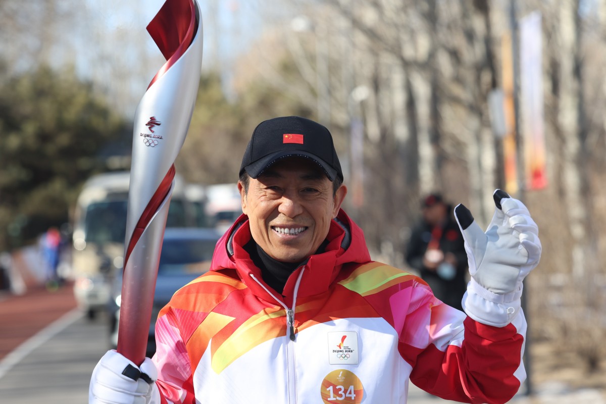 Director Zhang Yimou runs with the Olympic torch in Beijing on Wednesday, the first day of the relay. Photo: Xinhua