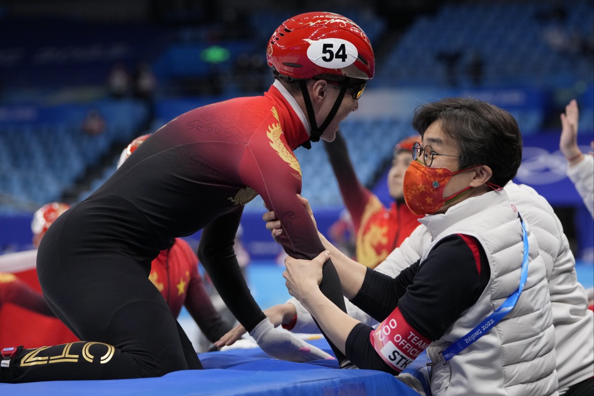 Ren Ziwei of China is congratulated by coach Kim Sun-tae after their victory in the short-track speed skating mixed team relay at the Beijing 2022 Winter Olympics. Photo: AP/Natacha Pisarenko