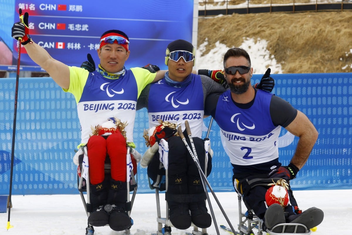 (From left) Beijing Winter Paralympic Games cross-country skiing men’s sprint sitting final event silver medallist Mao Zhongwu, gold medallist Zheng Peng and bronze medallist Collin Cameron at the Zhangjiakou Biathlon Centre. Photo: Reuters   