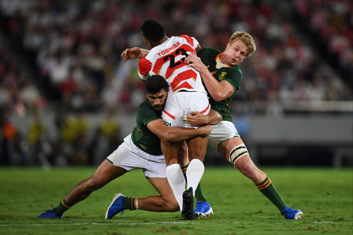 Pieter-Steph du Toit (right) and Damian de Allende (left) tackle Ataata Moeakiola during a friendly between Japan and South Africa. Photo: AFP