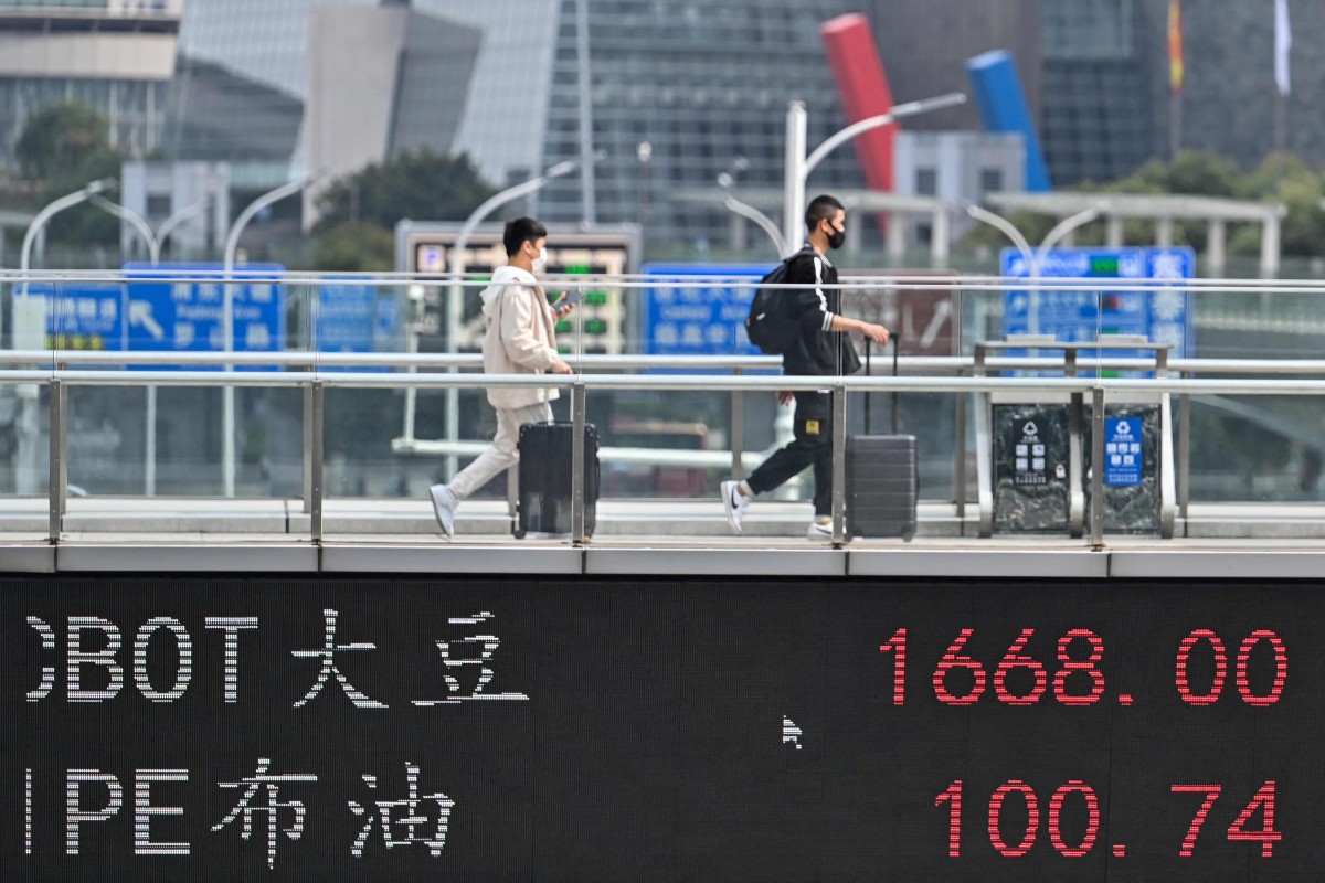 A display board showing commodity prices in Shanghai’s Lujiazui financial district on March 16, 2022. Photo: AFP