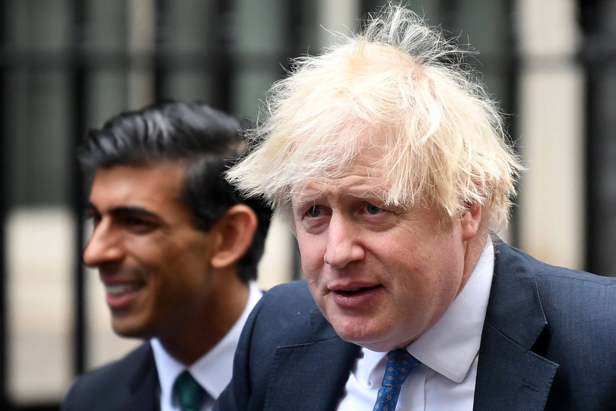 Britain’s Prime Minister Boris Johnson (right) stands with Britain’s Chancellor of the Exchequer Rishi Sunak during a meeting with Small Business Saturday entrepreneurs in Downing Street in central London in December 2021. Photo: AFP