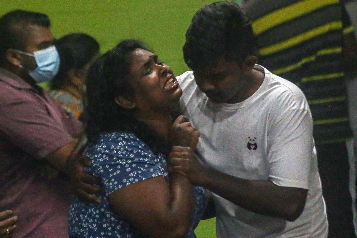 A family member reacts as the coffin carrying the body of Malaysian national Nagaenthran K. Dharmalingam arrives in Tanjung Rambutan, Malaysia, on Thursday. Photo: AFP