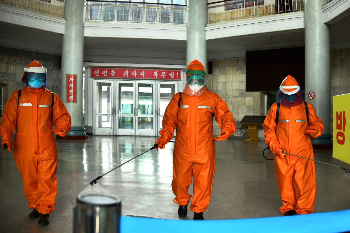 Workers disinfect Pyongyang’s train station grounds. Photo: KCNA/dpa