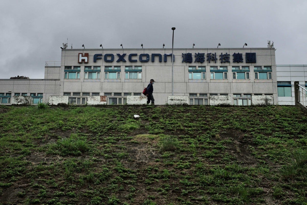This file photo taken on May 6, 2022 shows a man walking past the Foxconn headquarters in New Taipei City, Taiwan. Photo: AFP