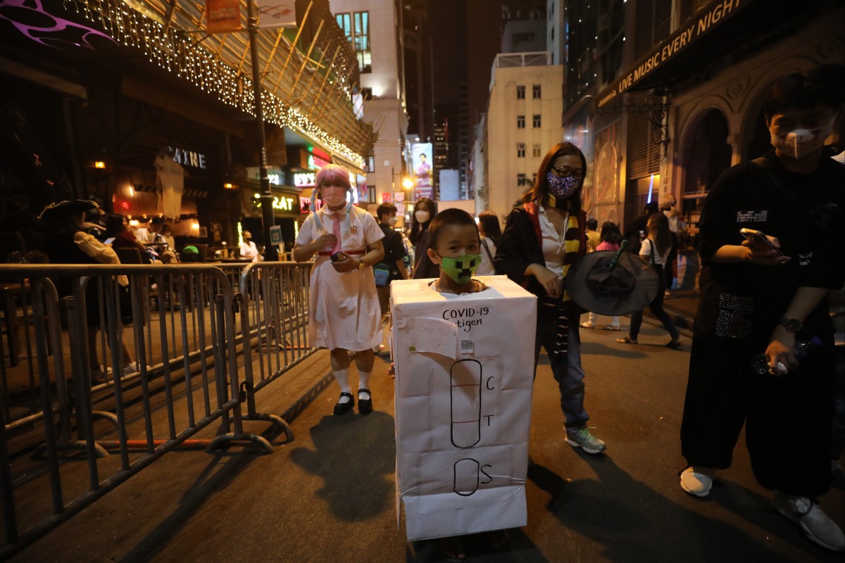 A child dresses up as an RAT test as part of Halloween celebrations in Lan Kwai Fong on October 30. Arrivals into Hong Kong now have to do two PCR tests and seven RAT tests. Photo: Xiaomei Chen