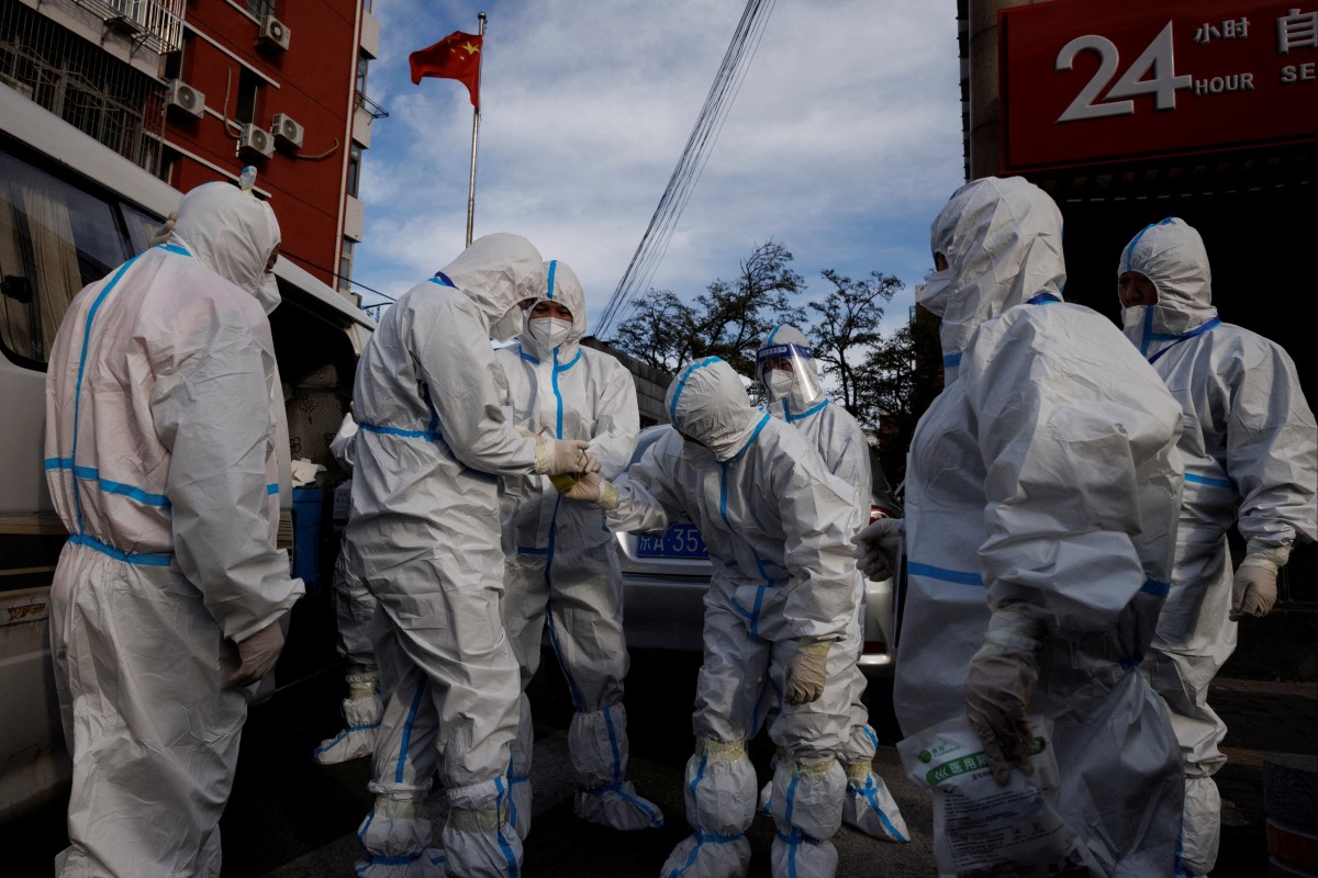 Pandemic prevention workers prepare to enter a locked-down apartment compound in Beijing amid a surge in Covid-19 cases. Photo: Reuters