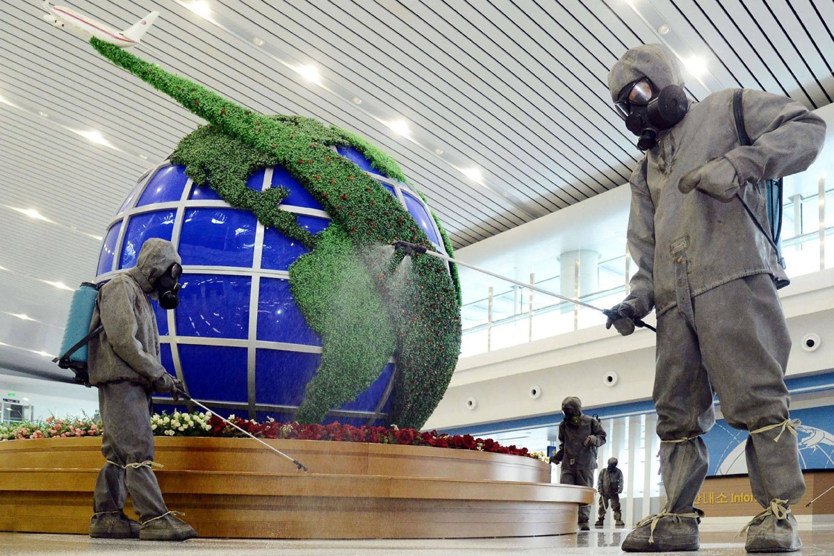 Workers disinfect the interior of Pyongyang airport in North Korea. File photo: KCNA via KNS/AFP