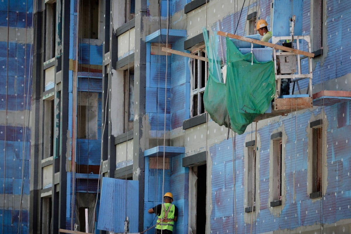 Men work at a residential construction site in Beijing. China has unveiled a slew of measures to revive the country’s real estate sector. Photo: Reuters
