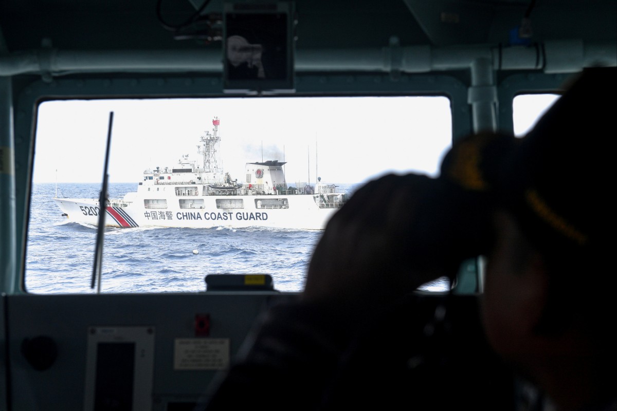 A China Coast Guard vessel is monitored by an Indonesian naval ship during a patrol at Indonesia’s EEZ north of the  Natuna Islands, in the South China Sea. Photo: Reuters