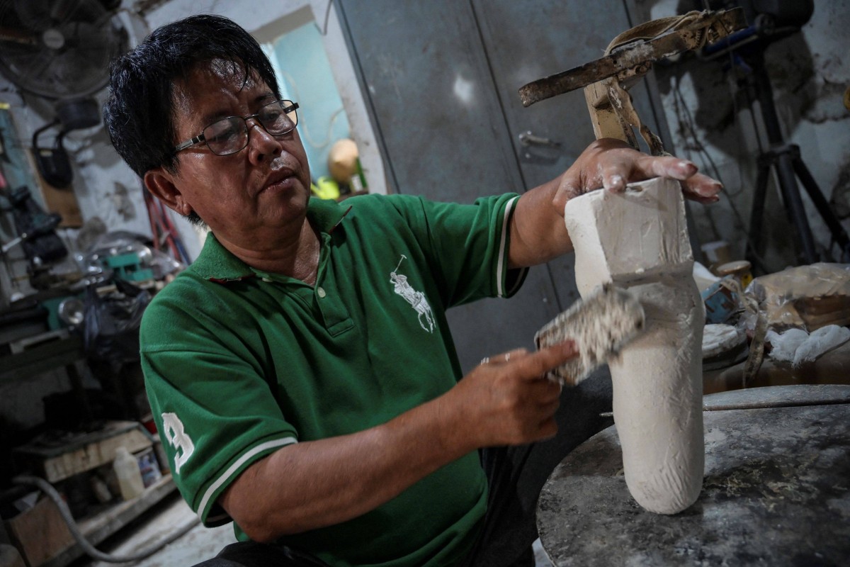 Former leprosy patient Ali Saga crafts prosthetic legs and hands inside his workshop in Tangerang to help people with disabilities to have access to artificial limbs at affordable prices. Photo: AFP