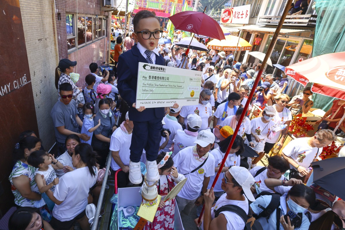 A child dressed as Financial Secretary Paul Chan joins the piu sik parade at the Bun Festival. Photo: SCMP