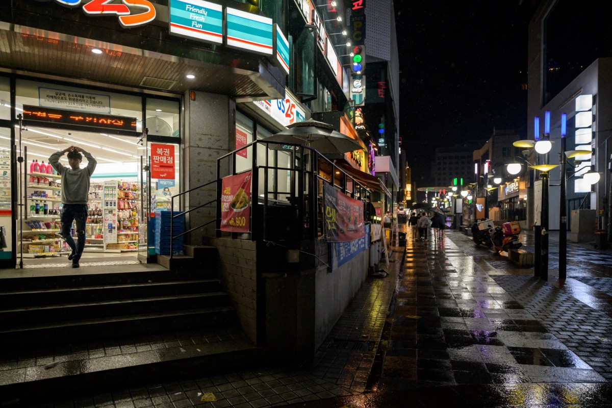 A man stands at the entrance to a convenience store on a quiet street in Jeju City, on Jeju Island. South Korean security authorities have reportedly uncovered two suspected secret Chinese “police stations” in the southern island province. Photo: AFP
