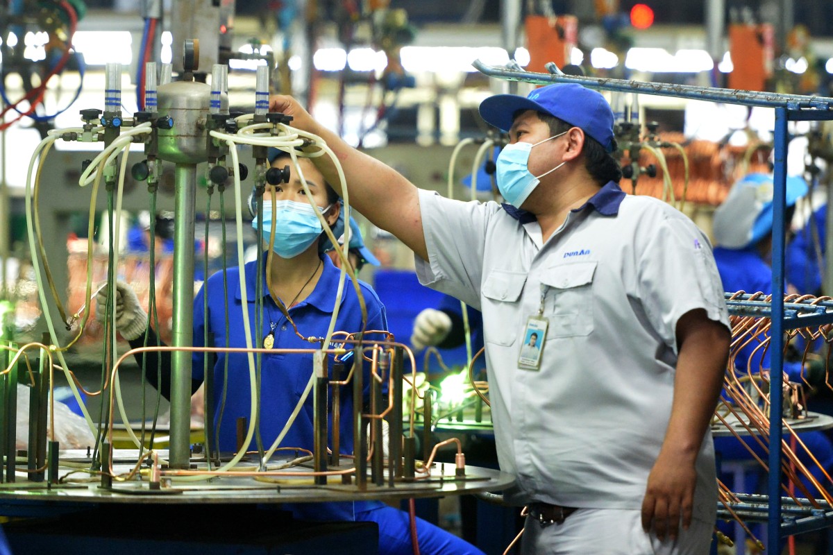 People work on a production line at a metals factory in Thailand. Photo: Xinhua