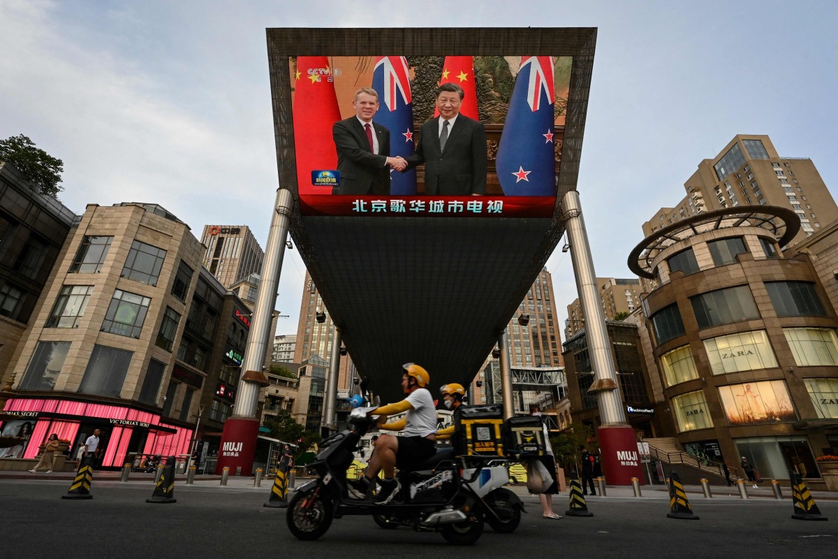 An outdoor screen shows news coverage of New Zealand’s Prime Minister Chris Hipkins meeting with China’s President Xi Jinping in Beijing. Photo: AFP