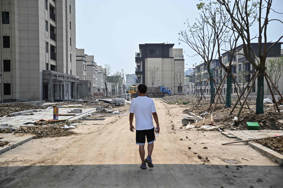 A homebuyer walking through a construction area in the compound where he bought an apartment in Ningbo, eastern Zhejiang province on June 2. Photo: AFP