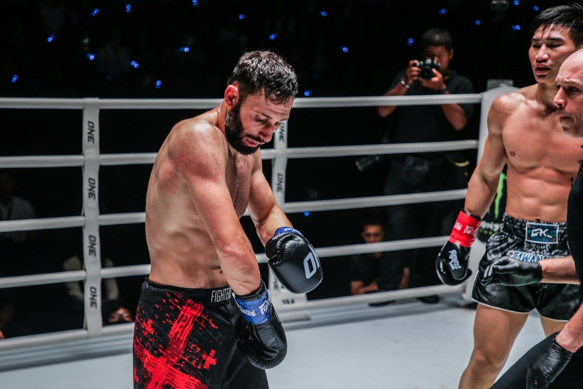Davit Kiria inspects his arm after a kick from Tawanchai. Photos: oNE Championship