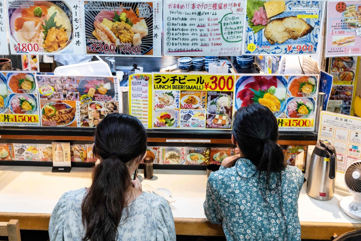 Customers wait for an early morning meal at a seafood restaurant at the Tsukiji fish market in Tokyo, Japan on August 22, 2023. Photo: AFP