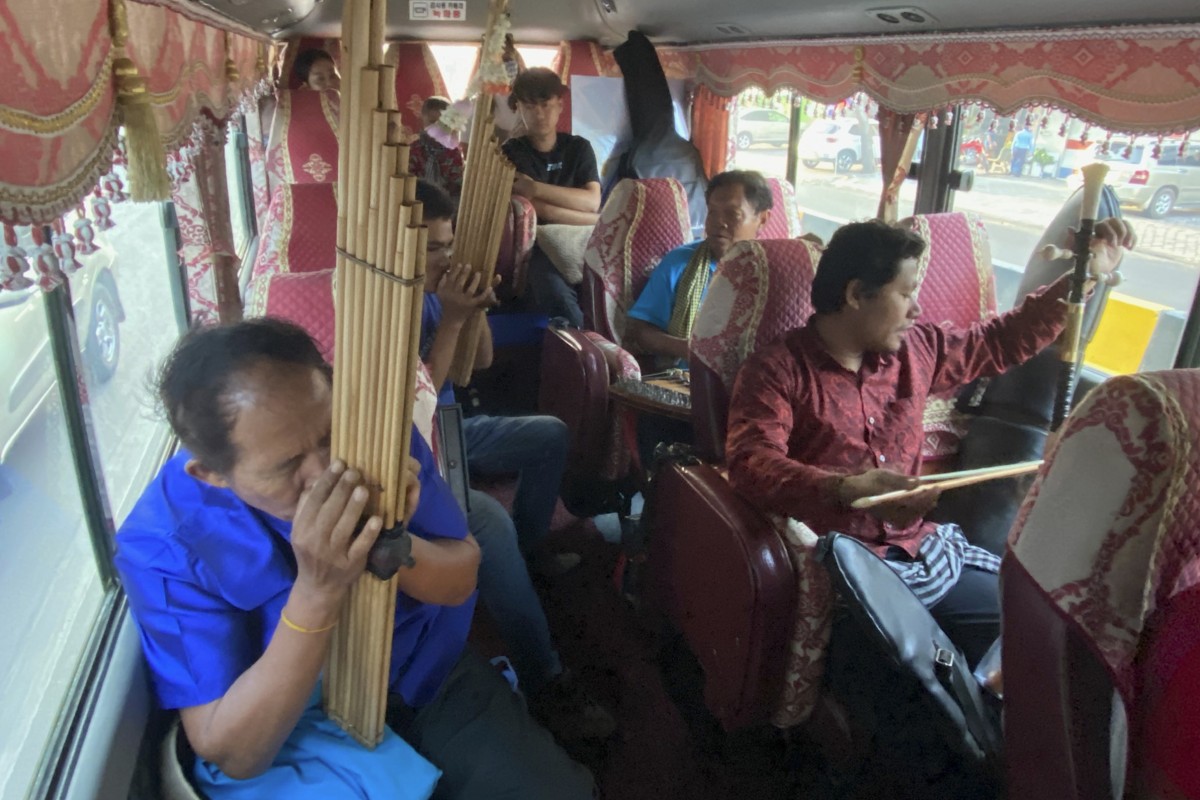 The Khmer Magic Music Bus band fills the bus with music as it sets out from Phnom Penh on a daylong journey in May, 2023. Clockwise from bottom left, Mon Hai, playing the khen mouth organ; Nou Samnang behind him, also on the khen; Thouch Savang, on the dulcimer-like kim, and Chek “Sinath”Samnang, on the tro khmer, a vertical fiddle.&#xA;&#xA;Credit: Patrick Scott
