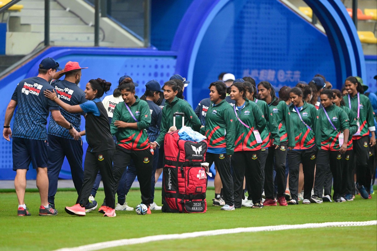 Players from Bangladesh and Hong Kong shake hands after their women’s quarter-final cricket match was abandoned due to rain. Photo: AFP