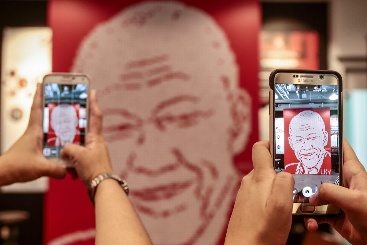 Visitors take photographs of a mural featuring the likeness of Lee Kuan Yew, during a tribute event in Singapore in 2016. The late political patriarch is said to have been vehemently opposed to having a personality cult growing around him. Photo: EPA