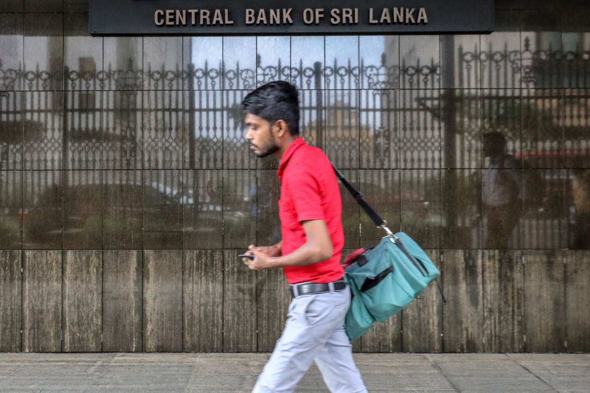 A man walks past the Central Bank of Sri Lanka in Colombo in September 2023. According to an IMF statement, revenue mobilisation gains in Sri Lanka improved relative to last year but are expected to fall short of initial projections by nearly 15 per cent by year end. Photo: EPA-EFE