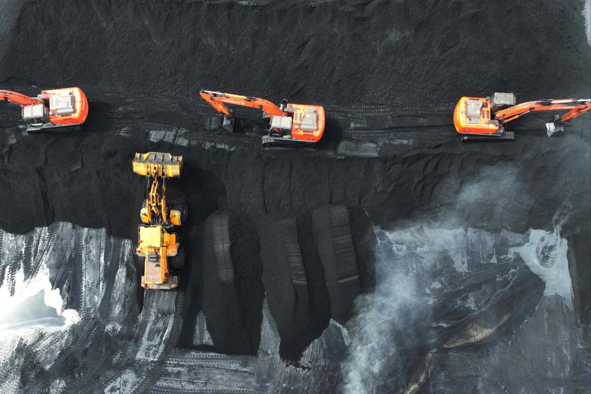 Diggers move coal at the port in Lianyungang, in China’s eastern Jiangsu province. China has more than 1.5 million coal miners who produce half of the world’s coal. Photo: AFP