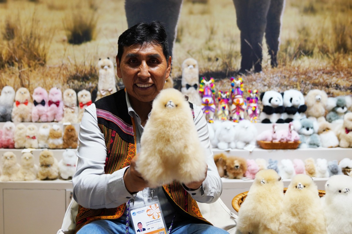 A Peruvian craftsman displays stuffed toys at a booth during the China International Import Expo on Tuesday. Photo: Xinhua