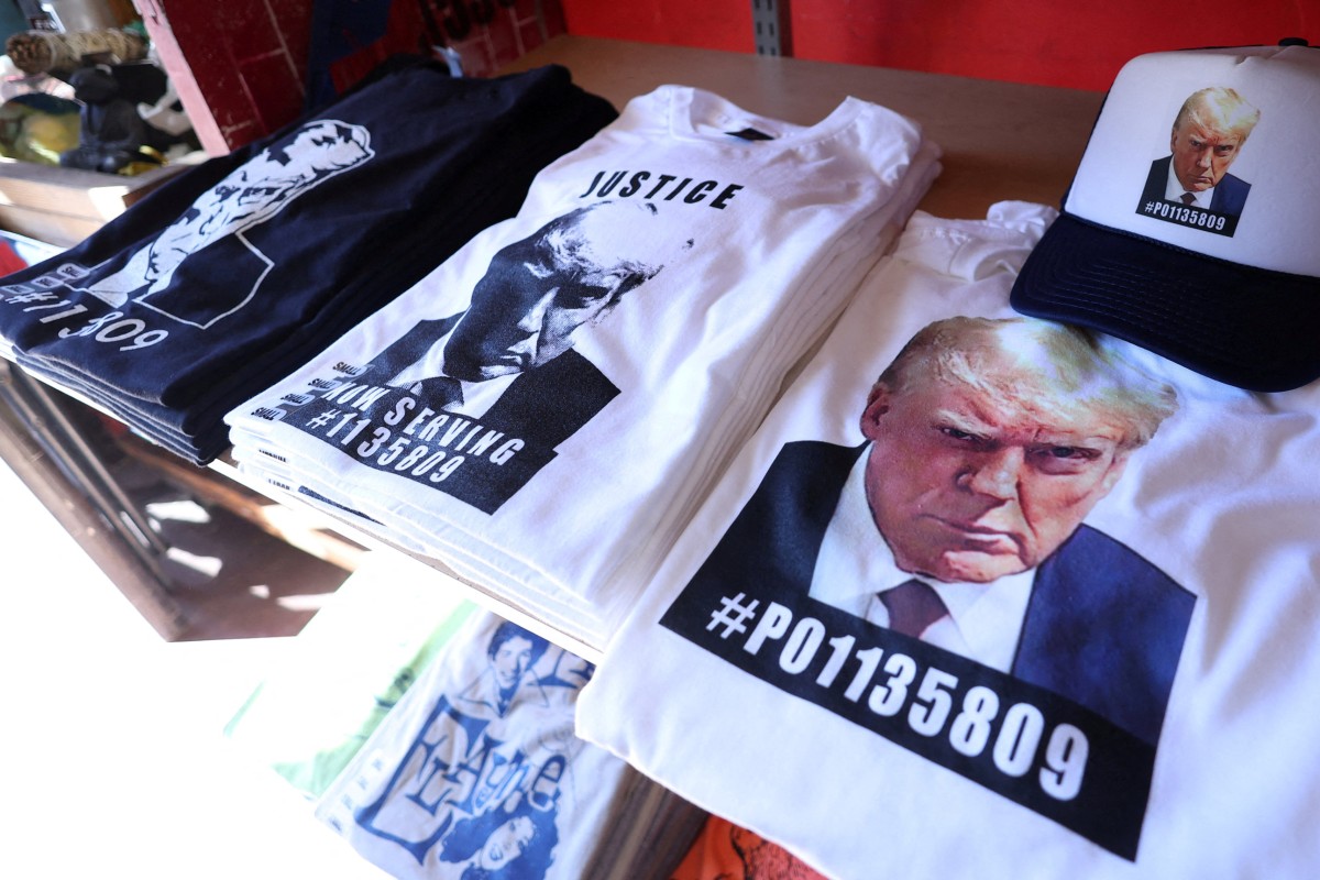 T-shirts and hats featuring Donald Trump’s mugshot. Photo: Reuters