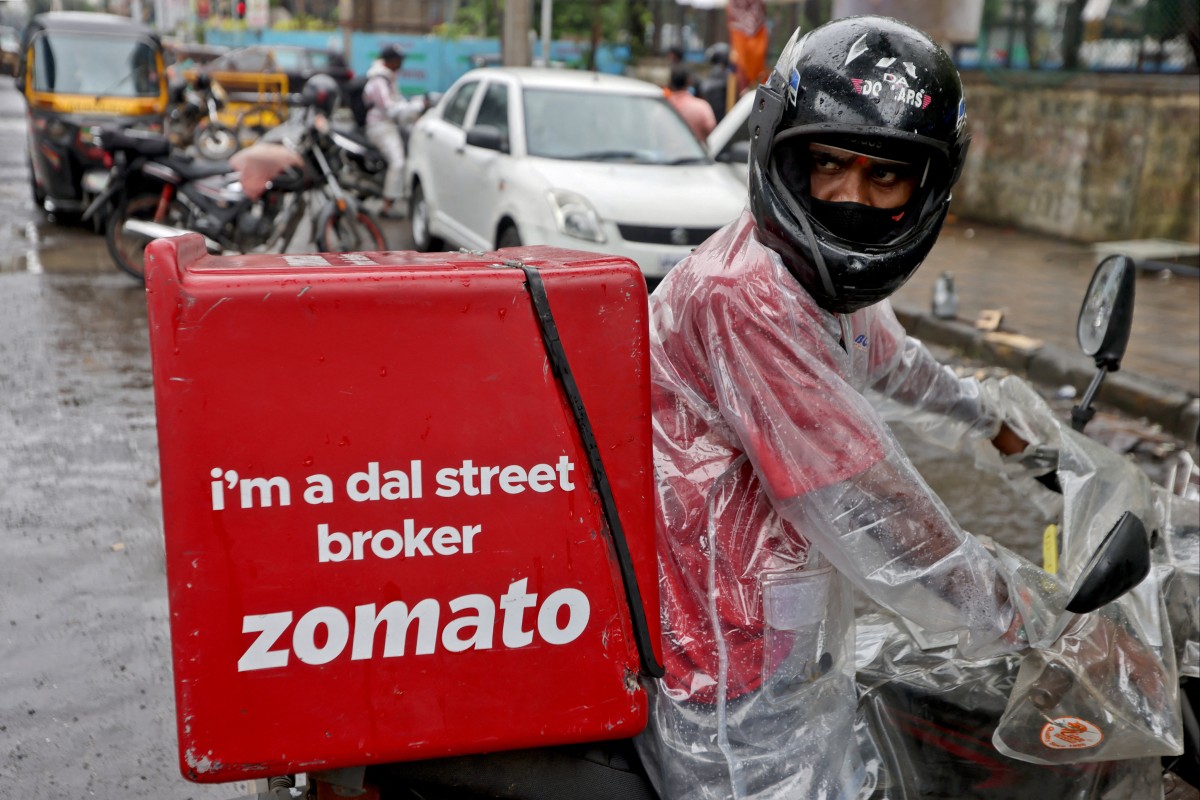 A delivery worker of Zomato, an Indian food-delivery startup, prepares to pick up an order from a restaurant in Mumbai. Photo: Reuters