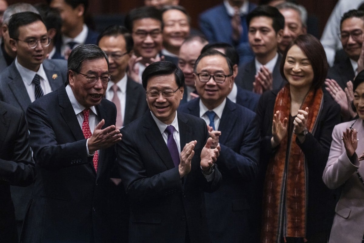 Hong Kong’s Chief Executive John Lee Ka-chiu applauds with lawmakers following the passing of the Article 23 national security legislation at the Legislative Council in Hong Kong on March 19. Photo: AP