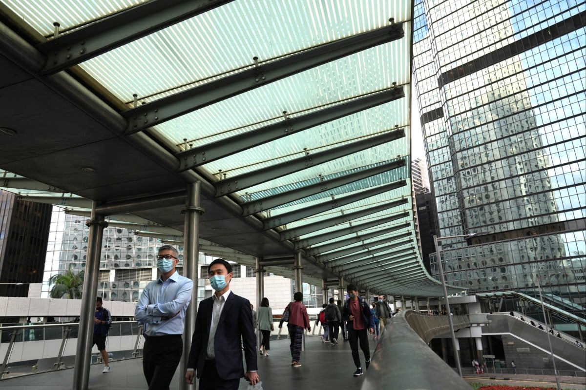 Pedestrians walk on a footbridge in Central, Hong Kong, on December 5, 2022. Photo: Sam Tsang