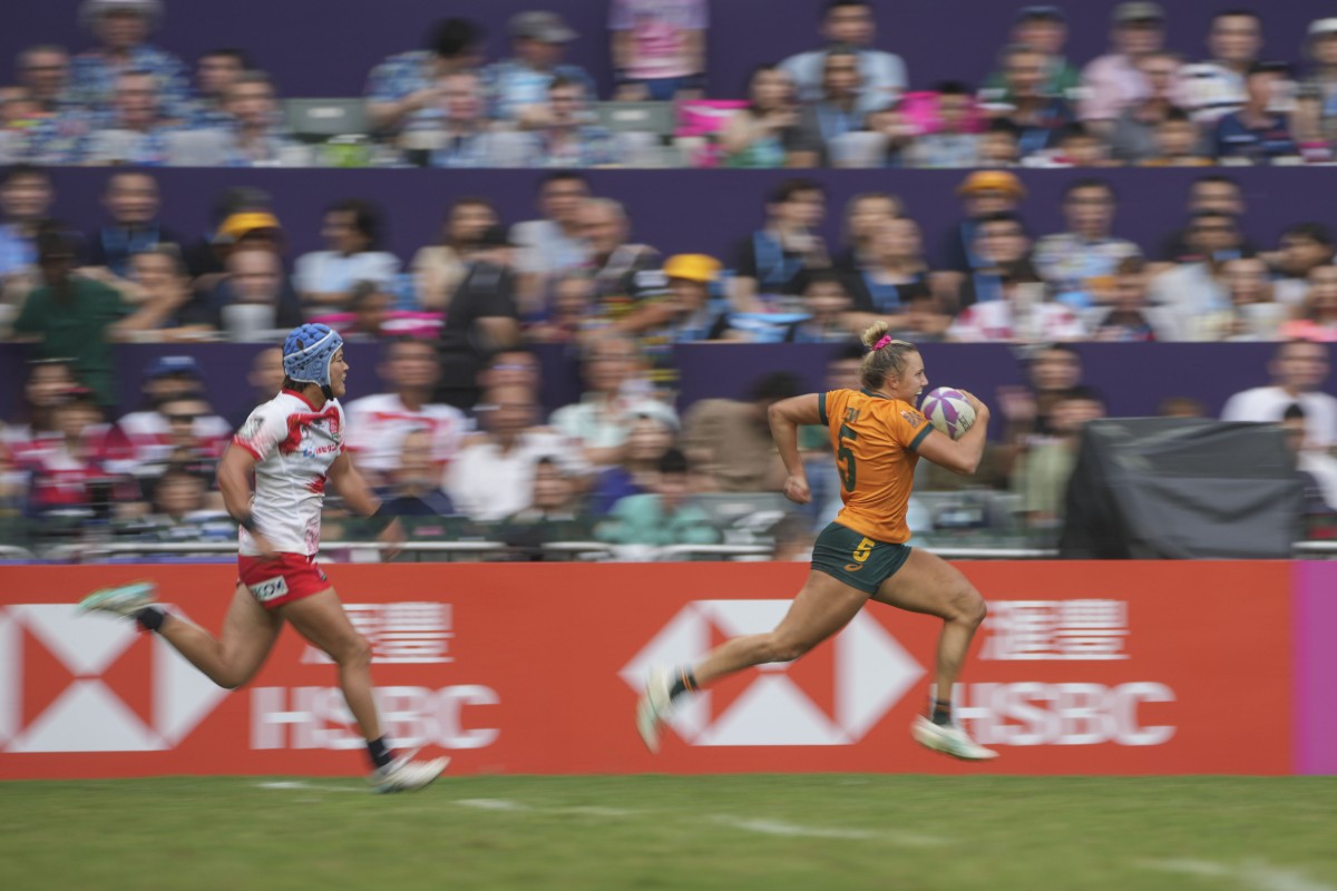 Australia’s Teagan Levi runs in a try, pursued by Japan’s Emir Tanaka on day two of the Cathay/HSBC Hong Kong Sevens. Photo: Sam Tsang