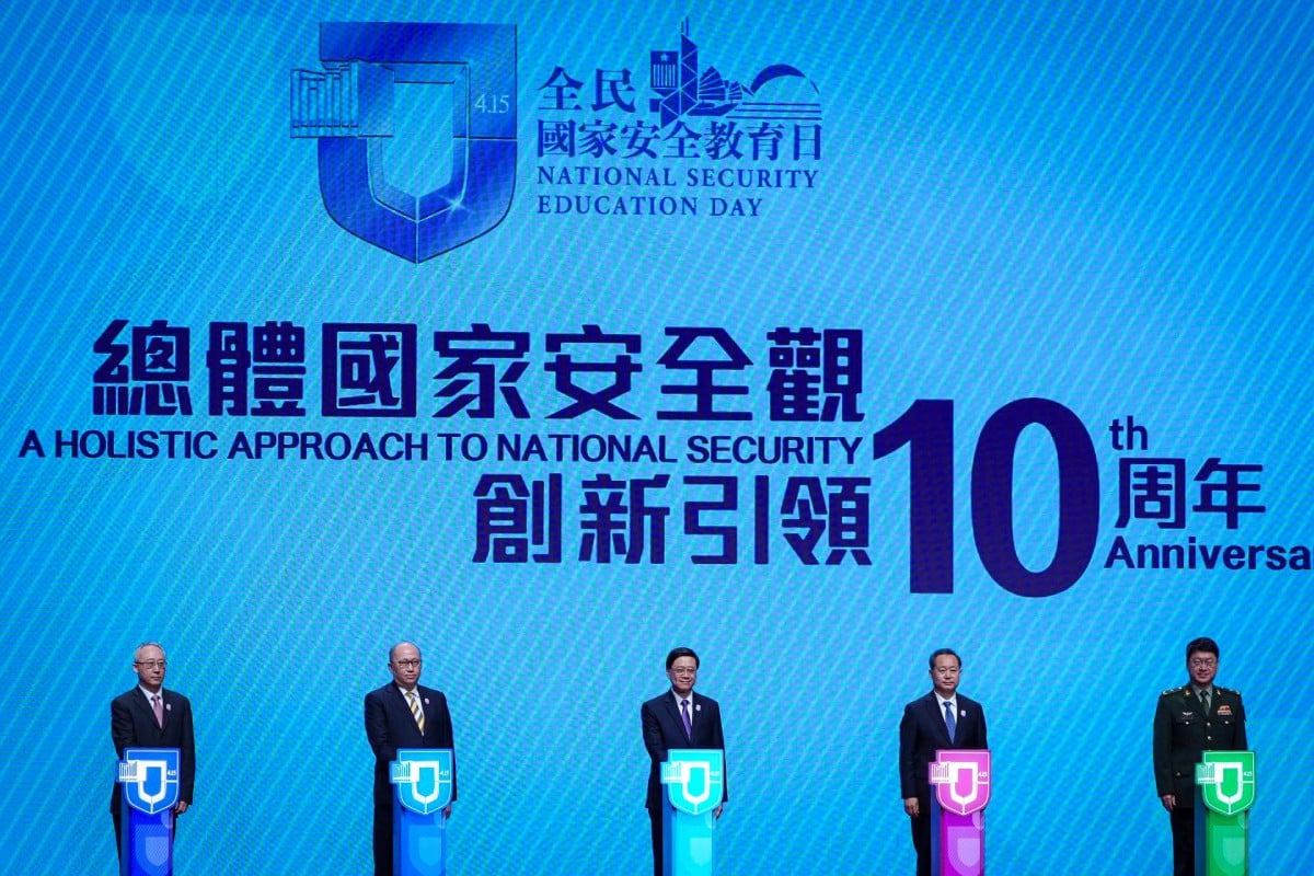 Officials pose for photos on stage at the Convention and Exhibition Centre. Photo: Eugene Lee