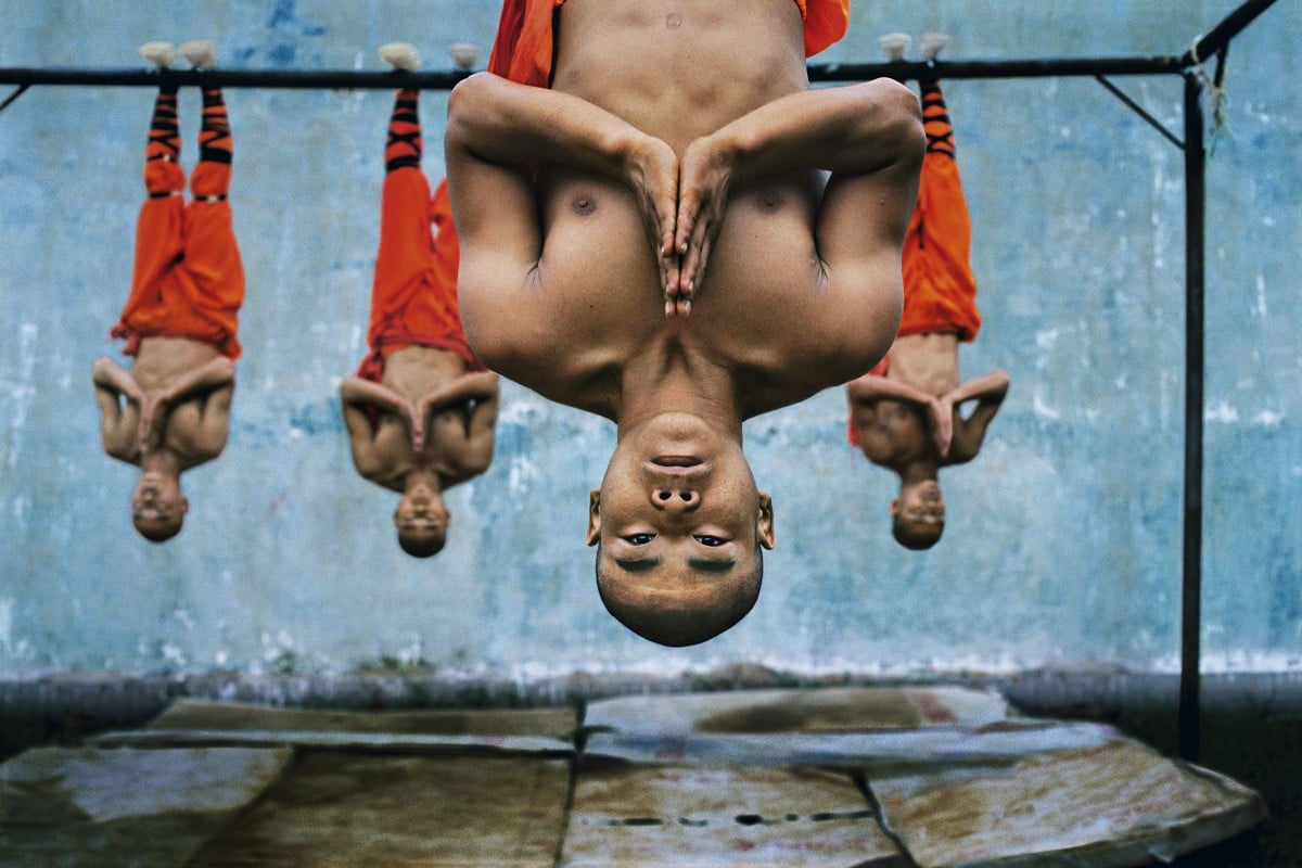 Steve McCurry’s photograph of monks suspended from a metal beam at the  Shaolin Monastery, in China, features in his new book, Devotion. The photographer talks about why he’s interested in human behaviour, and remaining respectful to gain access to sacred situations. Photo: Steve McCurry