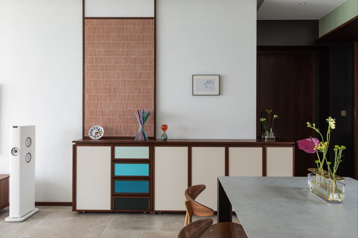 Cabinets on wheels in the living room of a Hong Kong apartment wrap around a corner. The homeowner was so impressed with the mid-century modern meets East renovation of the flat in Pok Fu Lam that she joined the design studio responsible. Photo: Harold de Puymorin