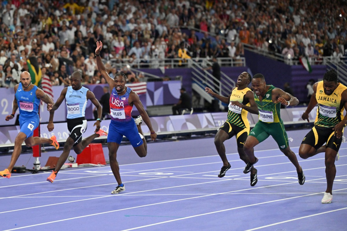 US’ Noah Lyles raises an arm as he crosses the finish in the men’s 100m final in Paris. Photo: AFP