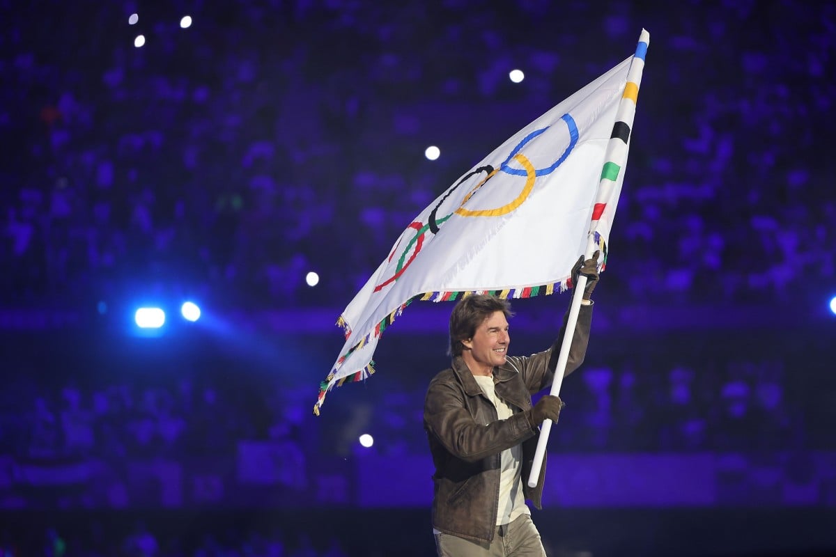 Tom Cruise carries the Olympic flag during the closing ceremony at the Stade de France. Photo: Xinhua