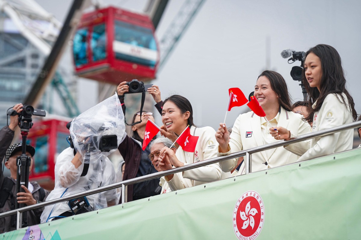 Smiles all round as the Hong Kong athletes fly the city’s flag in Central. Photo: Elson Li