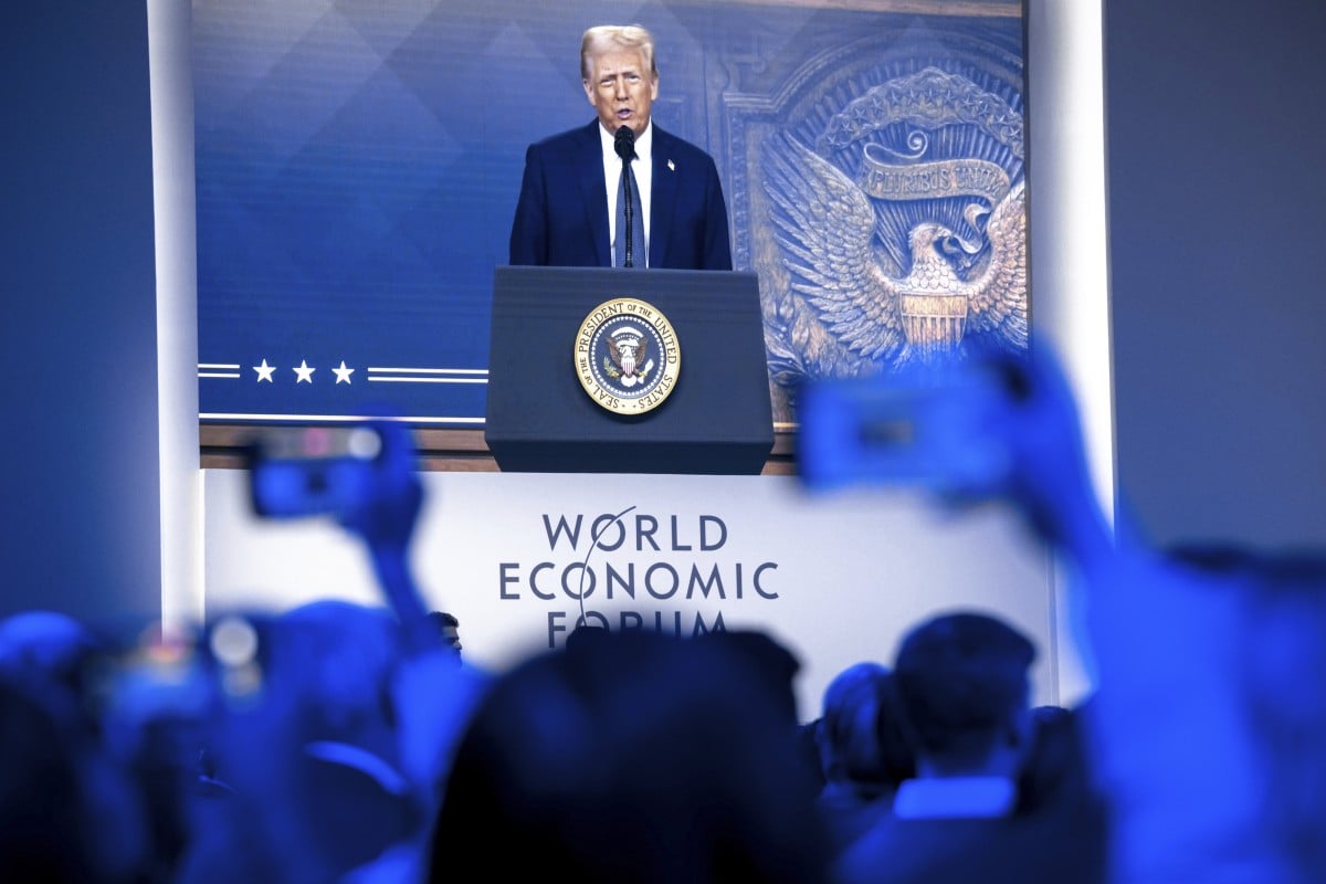 Trump is shown on screens as he addresses the WEF via remote connection. Photo: Keystone via AP