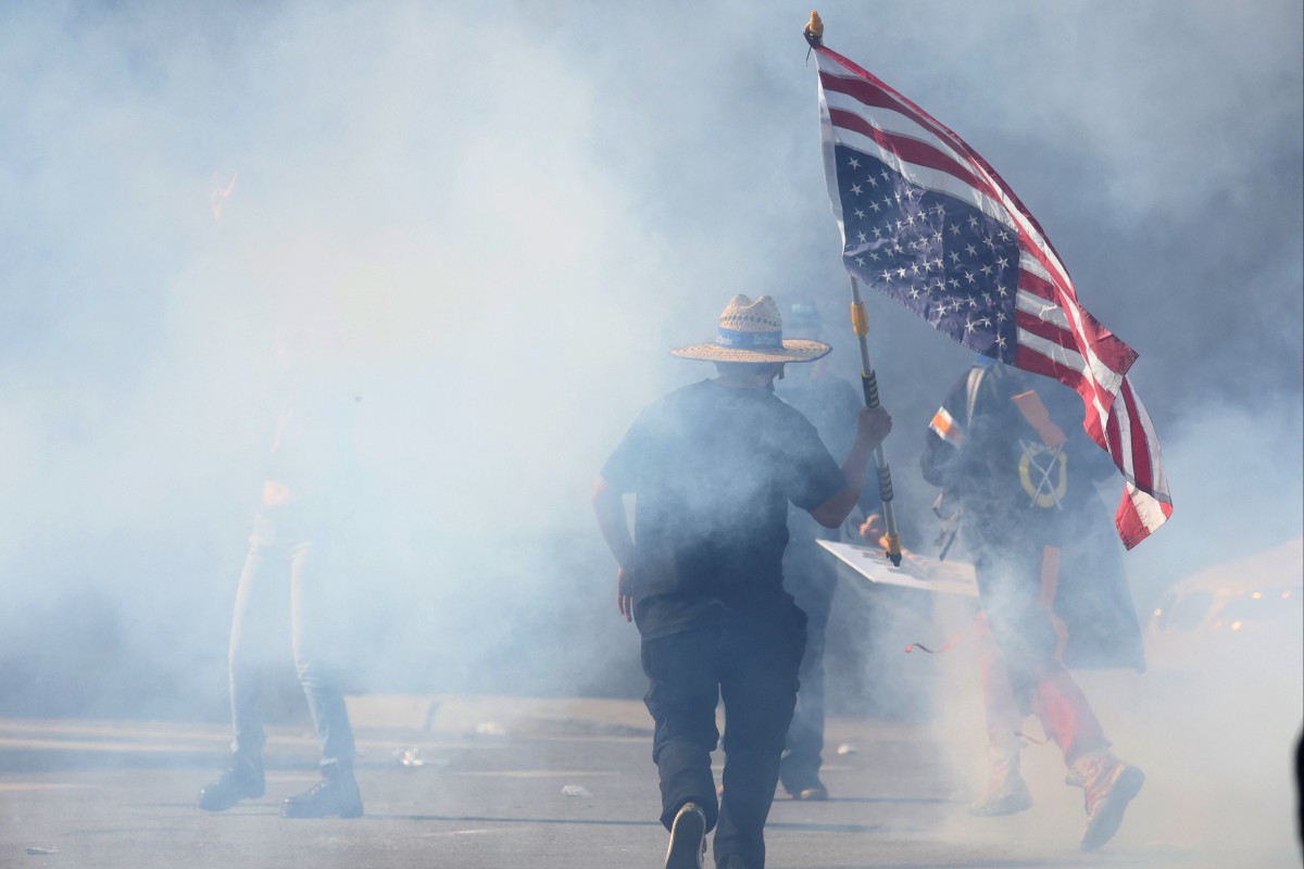 A demonstrator runs through tear gas during a “No Kings” protest against US President Donald Trump’s policies and federal immigration sweeps, in Los Angeles, California, on Saturday. Photo: Reuters