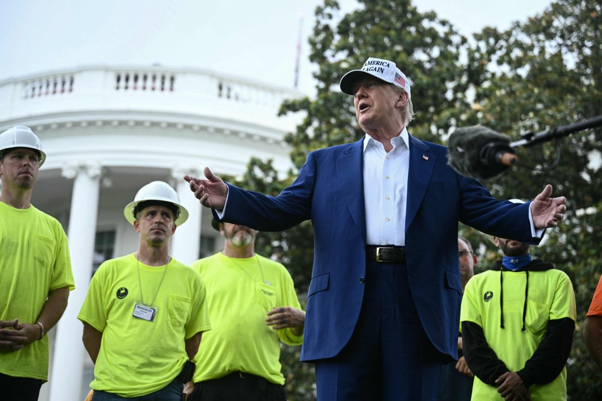 US President Donald Trump speaks to the press as workers install a large flag pole on the South Lawn of the White House in Washington on Wednesday. Photo: AFP