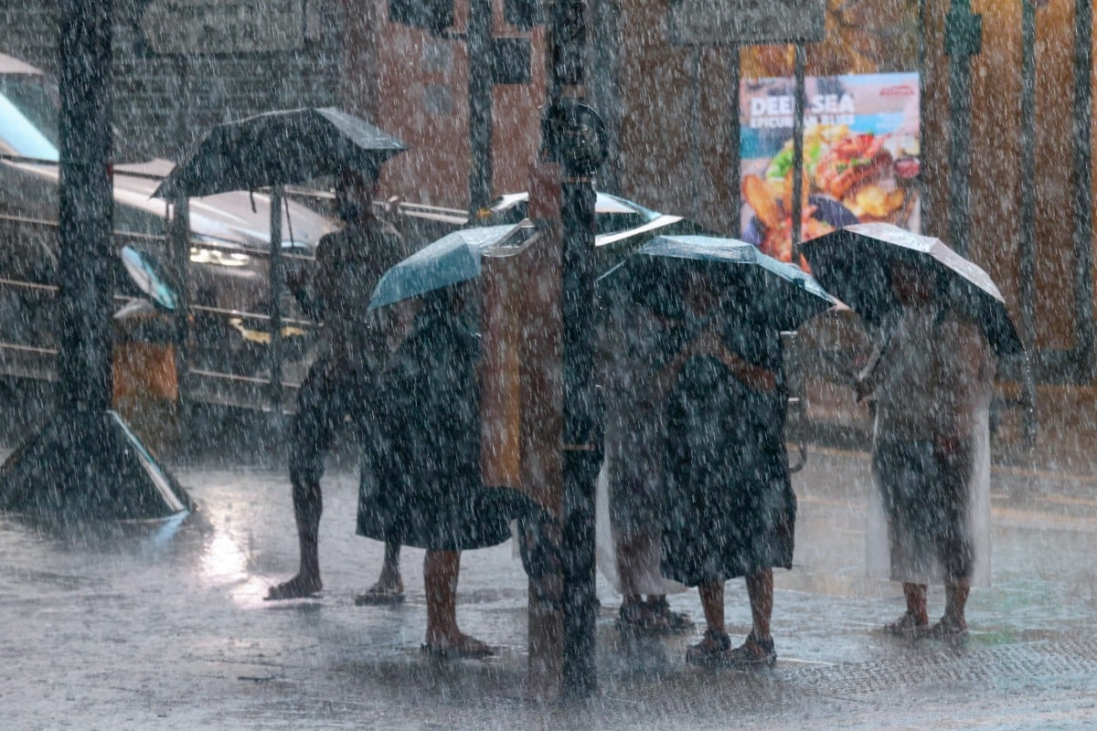 People brave the downpour during the black rainstorm warning, which is expected to last until 5.05pm. Photo: Jonathan Wong