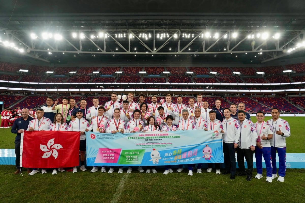 Hong Kong’s rugby sevens players pose with Rosanna Law Shuk-pui (front, centre), the sports minister and chef de mission of the city’s delegation, after they clinched National Games gold at Kai Tak Stadium. Photo: Sam Tsang